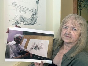 Basha Kresso, of Brantford, with a photo of her husband, longtime Brantford artist Hendrik Lenis who died in May aged 80.