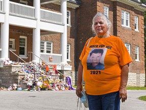 Loretta "Budgie" Nadeau of Orangeville stands in front of the Mohawk Institute, a former residential school in Brantford Ontario. The Algonquin woman from the Pikwakanagan First Nation has organized a three-day memorial Walk for Joe, in memory of her late brother Joe Commanda who died while trying to return home in 1968.