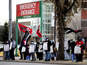 Strikers picket outside the University of Alberta Hospital, in Edmonton Monday Oct. 26, 2020. General support health-care workers, licensed practical nurses and health-care aides across Alberta went on a wildcat strike Monday morning to protest 11,000 job cuts announced by the provincial government.