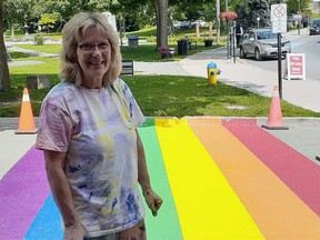 Lynn Pretsell, still splattered with paint, after the Pride flag painting was completed in Gananoque. Five hours later, it was defaced by a driver. Submitted photo