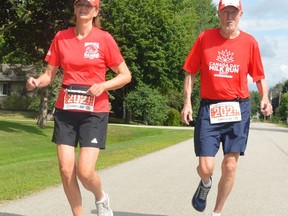 ON THE MOVE FOR FOOD BANK
Anne and Merv Hodgson take part in the second annual 'Together Individually' Canada Day Run/Walk in Mailtand on Thursday. Participants exited their homes at 10 a.m. and got moving in their own communities as part of the Brockville Road Runners Club fundraiser for the Brockville and Area Food Bank. The club's traditional 1-km and 5-km Canada Day races on the Brock Trail remain idled because of COVID-19 measures.
Tim Ruhnke/The Recorder and Times