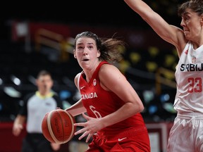 Canada's Bridget Carleton dribbles past Serbia's Tina Krajisnik in a women's preliminary-round Group A basketball match during the Tokyo Olympic Games at the Saitama Super Arena in Saitama on July 26. (Photo by Thomas COEX / AFP)
