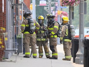 Chatham-Kent firefighters enter a business on Erie Street North while investigating a potential gas leak in downtown Wheatley on Monday. Mark Malone/Postmedia Network
