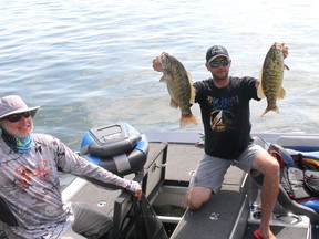 Bill Valberg, left of Tilbury, and Chad Wentzell, of St. Thomas, display two of the large bass they caught during the 2021 Mitchell's Bay Open on Saturday. They finished in third place with a total catch weighing 43.65 pounds.