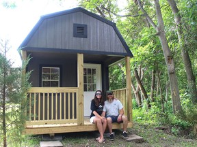 Bria and Tyler Atkins plan to put Dresden on the tourism map with Riverside Cabins on the Sydenham. They are seen here with the first of six cabins they plan to have  along the Sydenham River, located behind The Crappie Store, an outdoor and sporting goods company they operate. (Ellwood Shreve/Chatham Daily News)