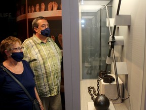 Wallaceburg residents Dave Warren and his mom Susan look at a display of some of the inhumane shackles that were used on slaves while visiting the Uncle Tom's Cabin Historic Site in Dresden on Saturday July 31, 2021. Ellwood Shreve/Chatham Daily News/Postmedia Network