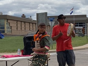 Melvin John drums as his granddaughter Manaya Duncan dances at a vigil to honour and remember those who died in Canadian residential schools. PHOTO BY KELLY-ANNE RIESS/POSTMEDIA