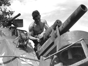 Bombardier B. W. Bailey Cleaning the Gun of an M7 Self-Propelled Priest, 19th Field Regt, RCA. Courtesy Library and Archives Canada