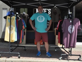 Mike Petrynka, owner of Mike's Printing and Apparel stands in front of his shop, surrounded by some of his merchandise on Sunday July 4, 2021 in Cornwall, Ont. Francis Racine/Cornwall Standard-Freeholder/Postmedia Network
