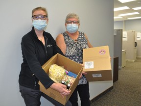 Bayshore Home Care Solutions nurse Monica Dion and manager of clinical practice Karen Chisholm pose with two of the 300 or so boxes that will be heading out to staff members this week. Photo taken on Wednesday July 7, 2021 in Cornwall, Ont. Francis Racine/Cornwall Standard-Freeholder/Postmedia Network