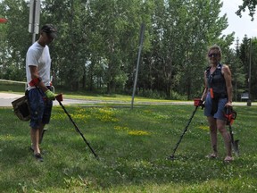 Claude Gibeault and Leah McMillan were busy metal detecting in front of the Cornwall Curling Centre on Thursday July 15, 2021 in Cornwall, Ont. Francis Racine/Cornwall Standard-Freeholder/Postmedia Network