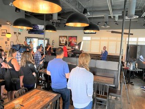 Mayor Jeff Genung speaks to a group including the local MP, MLA, members of the chamber and local business community at a launch for a new federally-funded ‘shop local’ campaign. Patrick Gibson/Cochrane Times