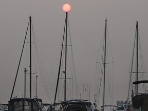 The sun rises over sailboats at the Lakeview Marina in Windsor on Tuesday, July 20, 2021. Southern Ontario is under a special air quality statement from Environment Canada as smoke from forest fires in northwestern Ontario blows southward.