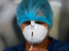 A healthcare worker draws a dose of COVID-19 vaccine.