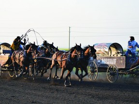 Kurt Bensmiller, left, drives hard around corner number four heading into the finish line Saturday during the Battle of the Foothills chuckwagon races at the High River Agricultural Society. He emerged as the day money winner with a penalty free run of 1:17.44. After thei first three days of racing, Vern Nolin leads Bensmiller by just 39 hundreds of a second heading into the second half of the Battle of the Foothills. Races take place this Friday and Saturday before wrapping up on Sunday, when the top four compete.