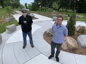 Dave Mowat, chief of Alderville First Nation, left, and Metis artist Terence Radford stand in the new Spirit Garden installation in Lake Ontario Park in Kingston, Ont. on Monday, June 21, 2021. Elliot Ferguson/The Whig-Standard/Postmedia Network