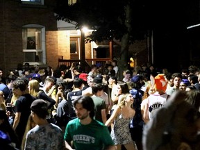Partygoers gather on Aberdeen Street near Queen's University in Kingston on Sunday, July 4.