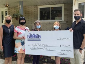 Gail Power and Mary Ambrose, l-r, from the Kingston Area Realtors Association presenting Catherine Oxford, Ruth Woodman, and Stuart Trior from the Kingston Youth Shelter with a cheque of $19,000 for the organization in Kingston, Ont. on Thur., July 15, 2021. Brigid Goulem/The Kingston Whig-Standard/Postmedia Network