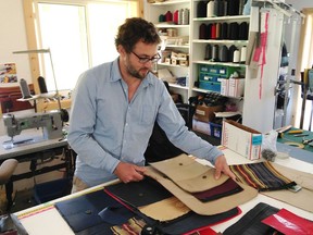Sven Schlegel of Mariclaro sustainable designs stands in the company's workshop in Snow Road Station, where leather from old luxury cars and airliners is recycled into items including purses, totes, shoulder bags, duffel bags and backpacks.