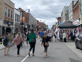 People walk up and down Princess Street, which was closed to vehicular traffic between Ontario Street and Division Street on Saturday, July 31, in conjuction with the Downtown Kingston Business Improvement Area's Stop, Sip and Stroll event.