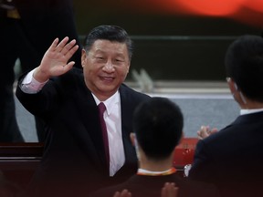 Chinese President Xi Jinping waves as he attends the art performance on June 28 celebrating the 100th anniversary of the founding of the Communist Party of China in Beijing, China.