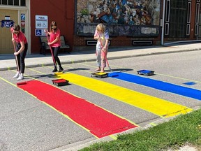 Visitor Centre staff help Lynn Pretsell paint the new Rainbow Walk in Gananoque. The walk helps brighten up the town for everyone as well as showing support for the local LGBT+ community.   
Supplied by Lynn Pretsell