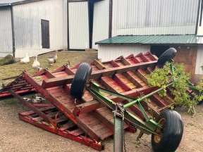 A suppertime storm flipped over a hay wagon and ripped nearly half the roof off of the Lawrence family barn just east of Meaford on 3rd Line Monday night. Bill Lawrence and his son Dawson were in the barn at the time of the storm but were able to remain safe throughout the quick damaging surge. Photo supplied.