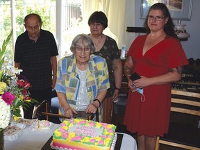 Photo by KEVIN McSHEFFREY/THE STANDARD
Irene Stoliker (cutting the cake) turned 100 years old on July 21. Her son, Brian, daughter Anne Fuglsang and granddaughter Jennifer Stoliker were among the people who dropped by to wish her a happy 100th birthday.