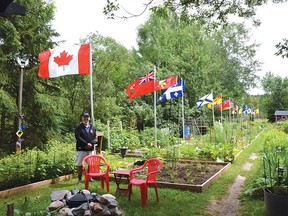 Photo by KEVIN McSHEFFREY/THE STANDARD
Jim Preston is a tenant at 1 Washington Crescent and a volunteer at the Washington Seniors’ Garden. He and other volunteers added flags to the garden for July Canada’s birthday month.