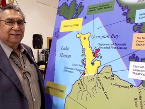 Former Saugeen First Nation chief Vernon Roote looked at a map outlining the treaties and the Bruce Peninsula land claim and aboriginal title claim to waterbeds in the traditional territory at the beginning of testimony in 2019 the James Mason Memorial Cultural and Recreation Centre at Saugeen First Nation.