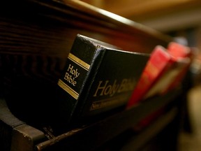Bibles and hymn books line the wooden pews in a church in this file photo.