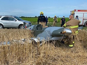 Emergency crews respond to a small single seater airplane that landed in a field as it attempted to land a private runway in Lakeshore on Saturday, July 3, 2021.