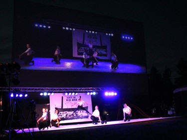 The entire three-hour long performance was projected onto the giant drive-in movie screen behind the temporary stage.