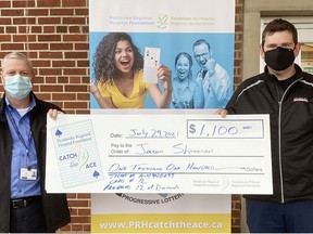 Roger Martin (left), executive director of the Pembroke Regional Hospital Foundation, presents Jason Shreenan with his cheque for $1,100 as the Week 1 winner of the Catch the Ace 3.0 lottery.