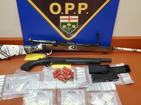 Kirkland Lake OPP released this photo of a seizure of drugs and weapons seized Wednesday after a pair of local searches.
