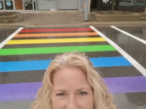 Oxford County Pride president Tami Murray stands in front of the rainbow crosswalk that was painted on Dundas Street near Museum Square this week in Woodstock.