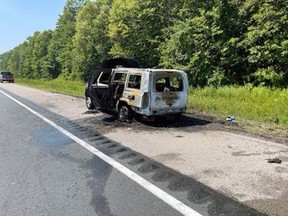 A vehicle caught fire Tuesday on Highway 402 east of Sarnia, but all occupants were able to escape without being injured, Lambton OPP say. (Twitter)