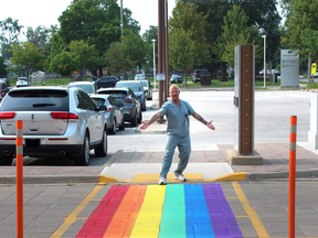 Bluewater Health employee, Brian Slaughter, poses with a new Pride crosswalk at Sarnia's hospital. A similar symbol of inclusion was also painted at Charlotte Eleanor Englehart Hospital in Petrolia, hospital group officials said. (Handout)