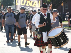 A drummer marches ahead of LiUNA Local 1089 workers in Sarnia's 2018 Labour Day Parade as they approach Front Street. A smaller, socially distanced version is returning to city streets Sept. 6.