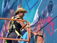 Layla Folkmann of Lacey and Layla Art, works on Spruce Grove's first mural entitled 'A Charm' on Friday. Folkmann and fellow artist Lacey Jane Wilburn were chosen to paint the mural as part of the City's first public art project. Kristine Jean