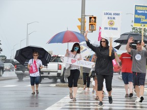 Family and friends of striking USW 6500 members, along with supporters from the local labour community, take part in a rally Wednesday afternoon at the Four Corners. Many of the signs read: "We stand by you, as you fight for them," in reference to the union's concern for the next generation of Vale workers.