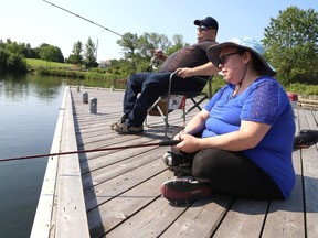Dan and Colette Berube soak up the sun while trying their luck at fishing at Ramsey Lake in Sudbury, Ont. on Wednesday July 14, 2021. The couple were celebrating Colette's birthday by fishing, which is one of her favourite things to do. John Lappa/Sudbury Star/Postmedia Network