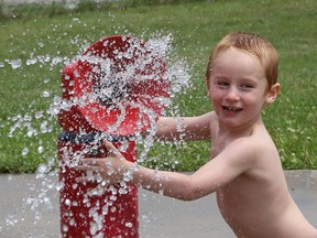 Kyson Boucher, 3, cools off at the splash pad at the Howard Armstrong Recreation Centre in Hanmer, Ont. on Wednesday July 14, 2021. Environment Canada said Greater Sudbury can expect 30 to 40 mm of rain with a risk of a thunderstorm on Thursday. Temperature will be steady near 18 C. John Lappa/Sudbury Star/Postmedia Network
