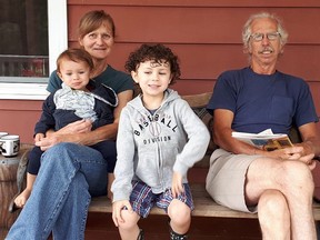 Farmer Max Burt and his beautiful wife, Joanne, never sit down, so busy with so much on their amazing farm, yet here they are with their grandchildren (Gilbert, left, and Gabriel). Don't be surprised if they leapt up after this photograph was taken. Supplied