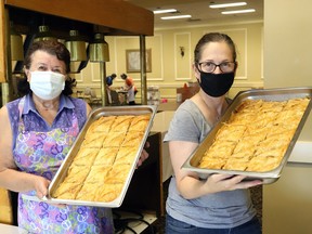 Angela Zografos, left, and Marsha Smith display baklava that will be available at the Sudbury Greek Festival at the Hellenic Centre in Sudbury, Ont. on July 23-24. The festival is offering takeout service only. Festival hours are noon to 8 p.m. each day. John Lappa/Sudbury Star/Postmedia Network