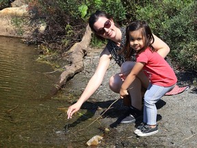 Leslie Pinto and her daughter, Charlotte, 2, play near the water at Lake Laurentian in Sudbury, Ont. on Wednesday July 21, 2021. John Lappa/Sudbury Star/Postmedia Network