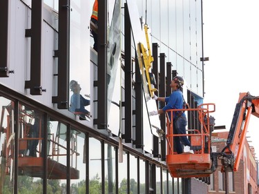 Glass panels were being installed at Place des Arts in downtown Sudbury, Ont. on Tuesday July 27, 2021. The northbound curb lane on Elgin Street between Medina Lane and Larch Street will be closed from 7 a.m. to 5 p.m. until July 29, 2021 while the work is completed. John Lappa/Sudbury Star/Postmedia Network