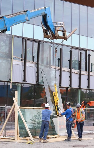 Glass panels were being installed at Place des Arts in downtown Sudbury, Ont. on Tuesday July 27, 2021. The northbound curb lane on Elgin Street between Medina Lane and Larch Street will be closed from 7 a.m. to 5 p.m. until July 29, 2021 while the work is completed. John Lappa/Sudbury Star/Postmedia Network