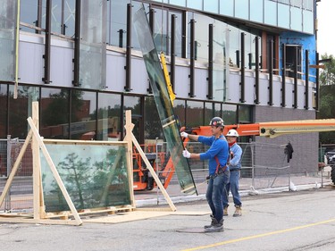 Glass panels were being installed at Place des Arts in downtown Sudbury, Ont. on Tuesday July 27, 2021. The northbound curb lane on Elgin Street between Medina Lane and Larch Street will be closed from 7 a.m. to 5 p.m. until July 29, 2021 while the work is completed. John Lappa/Sudbury Star/Postmedia Network