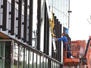 Glass panels were being installed at Place des Arts in downtown Sudbury, Ont. on Tuesday July 27, 2021. The northbound curb lane on Elgin Street between Medina Lane and Larch Street will be closed from 7 a.m. to 5 p.m. until July 29, 2021 while the work is completed. John Lappa/Sudbury Star/Postmedia Network